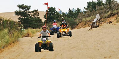 Kids and Families ATVing on the Untamed Dunes near North Bend, Oregon