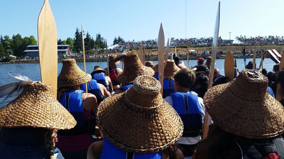 The CTCLUSI Tribe in traditional canoe.