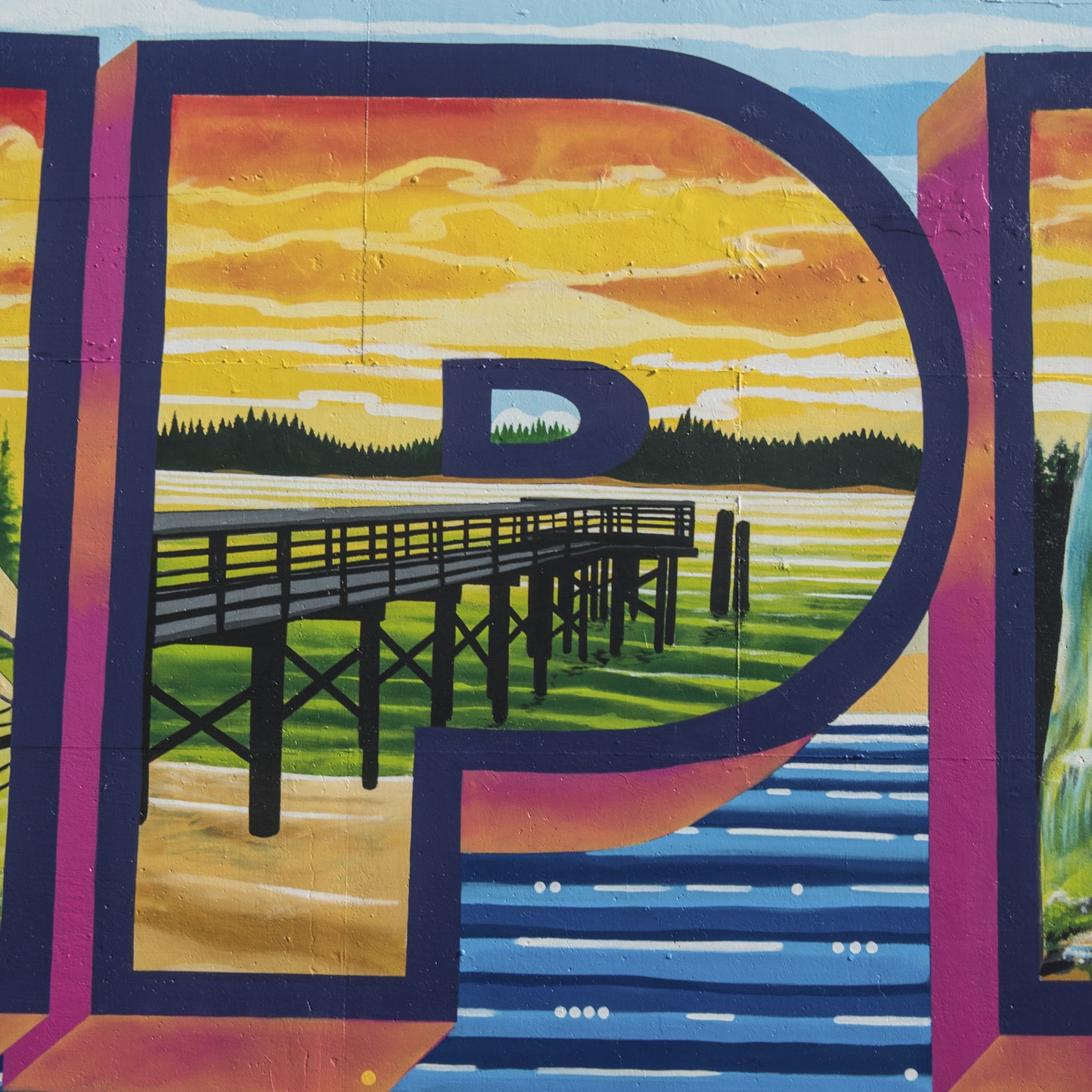 Close-up detail of the Empire Welcome Mural showing the letter “P” filled with a painted scene of the Hollering Place pier in the Empire District of Coos Bay, with a wooden walkway extending over the water beneath a colorful sky. Close-up detail of the Empire Welcome Mural showing the letter “P” filled with a painted scene of the Hollering Place pier in the Empire District of Coos Bay, with a wooden walkway extending over the water beneath a colorful sky.