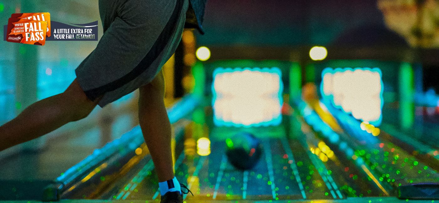 Bowler mid-throw on a colorful glow-in-the-dark bowling lane, with Fall Pass promotional badge
