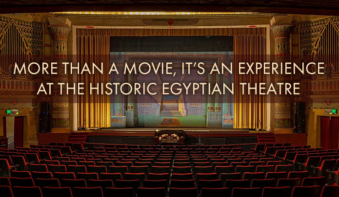 Interior of grand Egyptian theatre with text reading ‘more than a movie, it’s an experience at the historic egyptian theater’