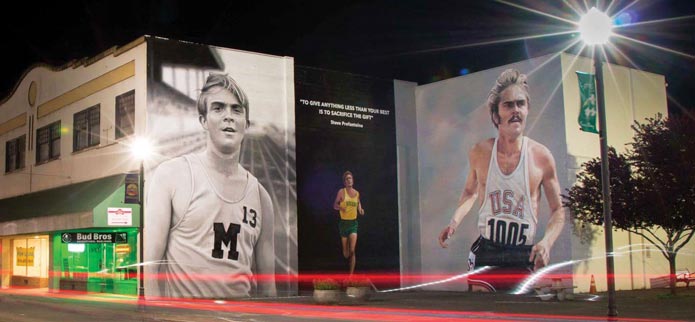 Steve Prefontaine murals in downtown coos bay, oregon at night