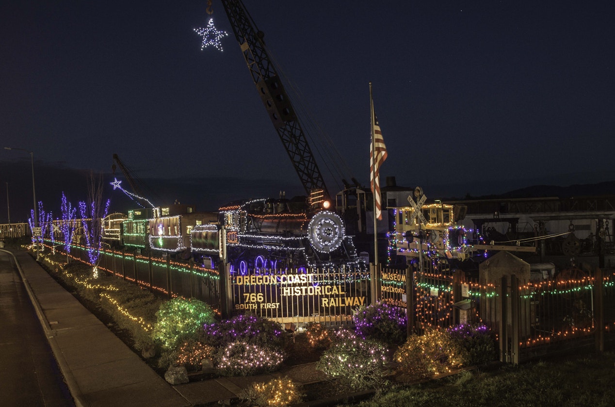 Thousands of colorful holiday lights illuminate historic railroad and logging equipment at the Oregon Coast Historical Railway Museum from November 28 through New Year’s Day, creating a vibrant outdoor display in the heart of Downtown Coos Bay.