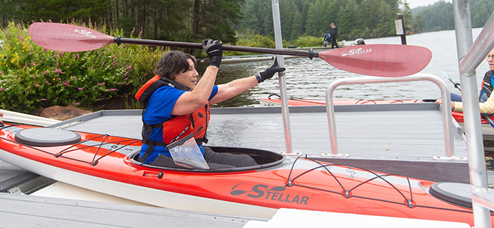 Photo courtesy of TSOC woman in red kayak at accessible kayak launch